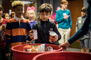 Lower and Middle schoolers bring canned goods for Turkey Train