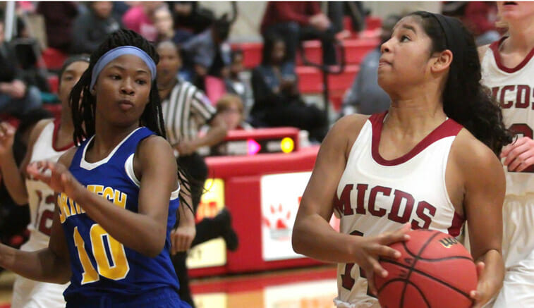 Rachel Thompson (right) of MICDS drives as Cheyenne Jordan of North Tech defends during a game in the Carlei's Wish Shootout at Ursuline Academy in Oakland