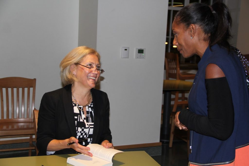 Neurologist Frances Jensen signs her book