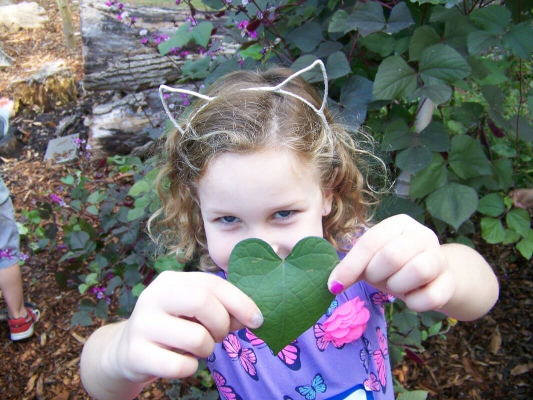 SK Student shows off a leaf while visiting the green center