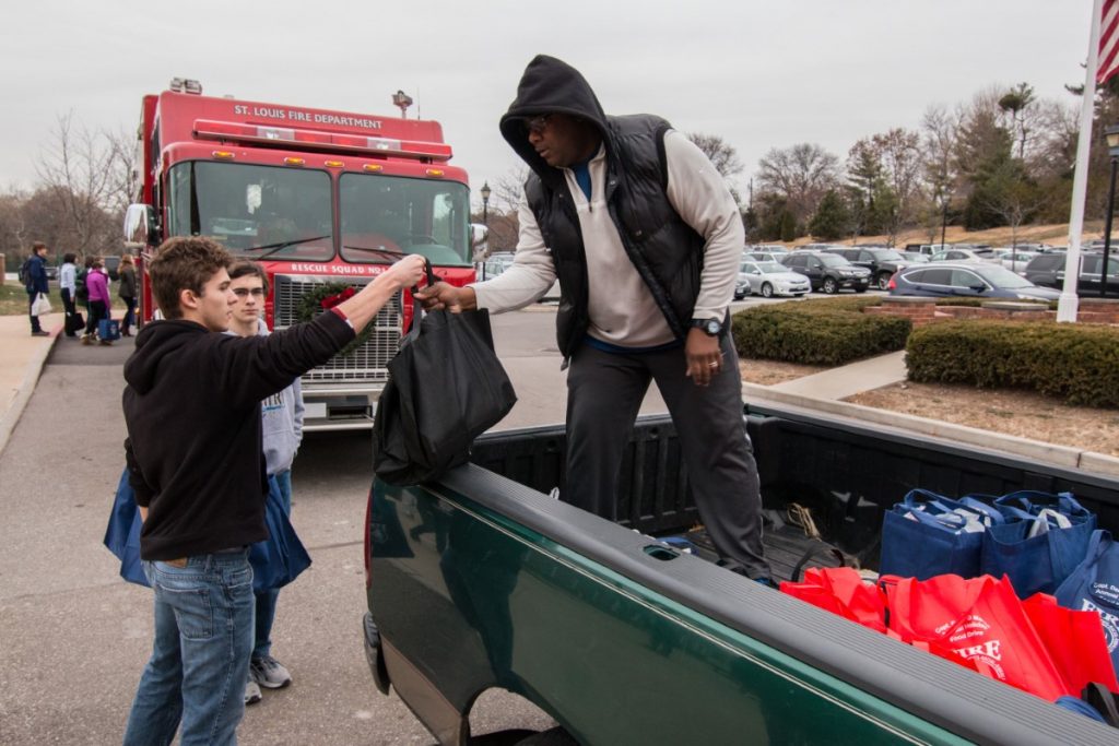 Students help fill the truck for the Derek D. Martin Food Drive