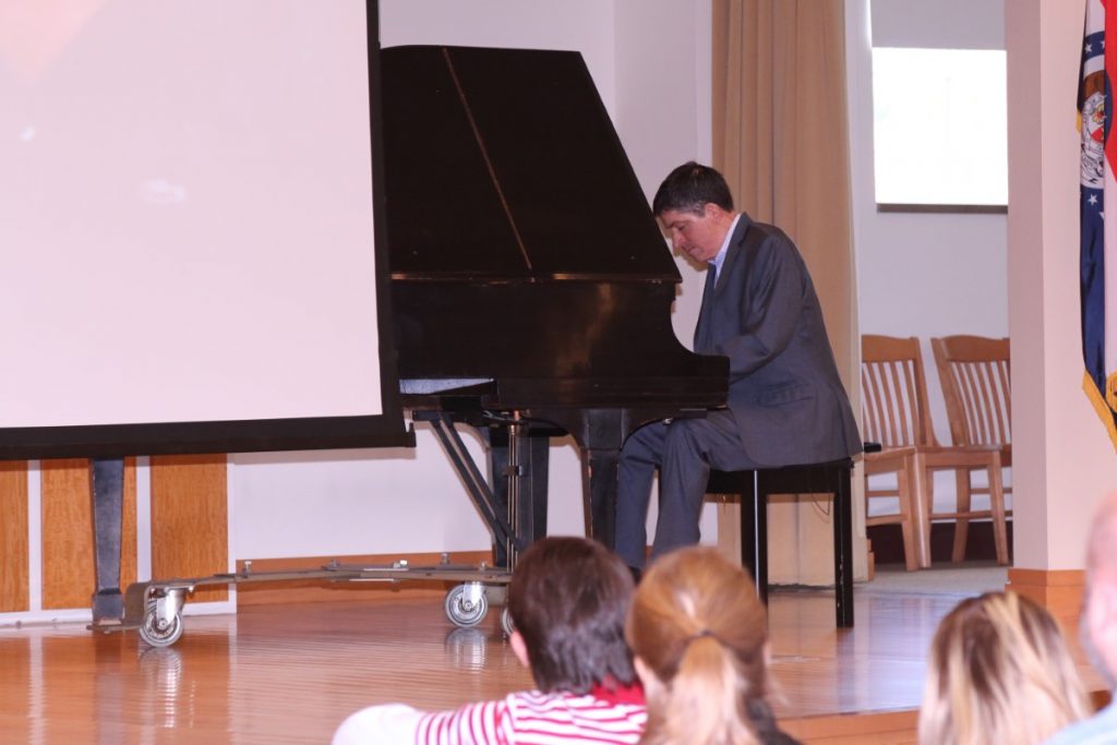 John O'Leary playing the piano for the students