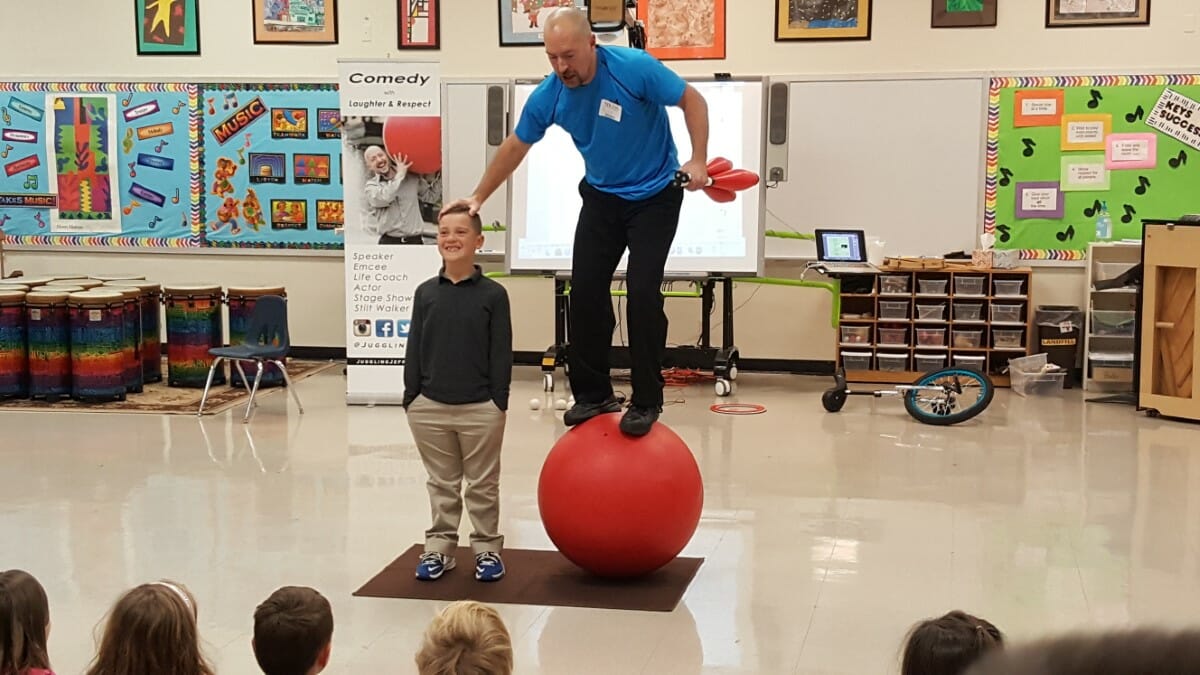 Juggling Jeff balances atop a ball and performs for the lower school