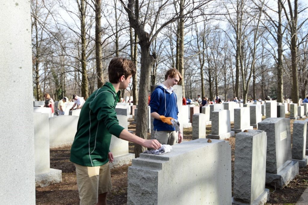 Students help clean up the vandalized cemetery