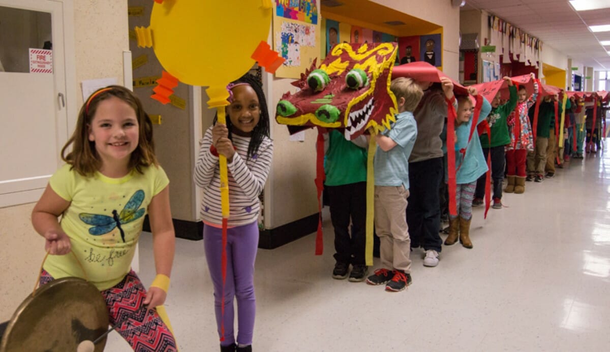 Students carry the dragon through the halls of Beasley