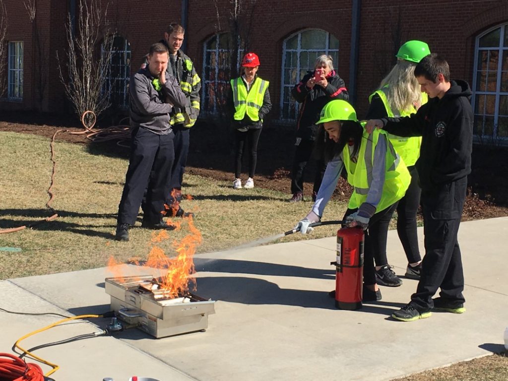 Students practice putting out fires for Teen CERT