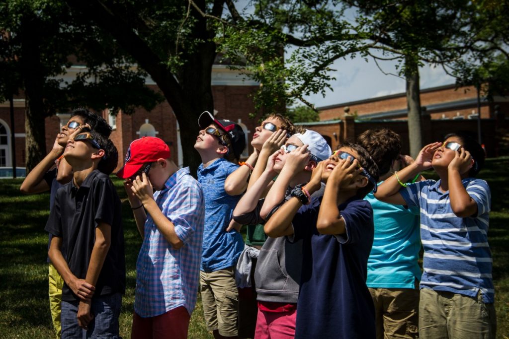 Students stare at the sun wearing protective eyewear