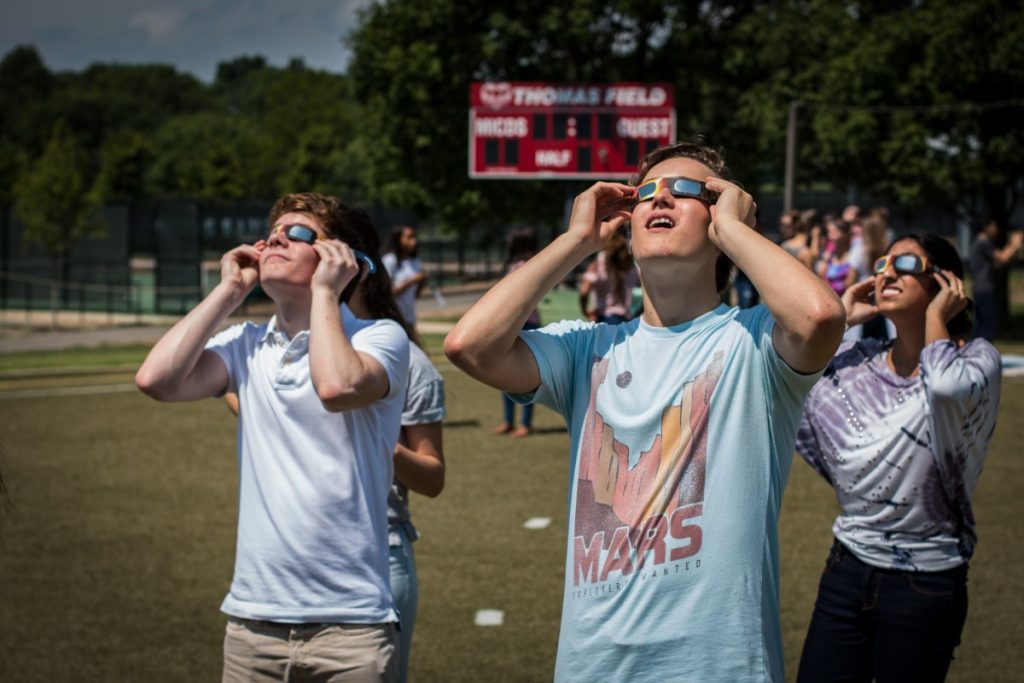 Students stare directly at the sun