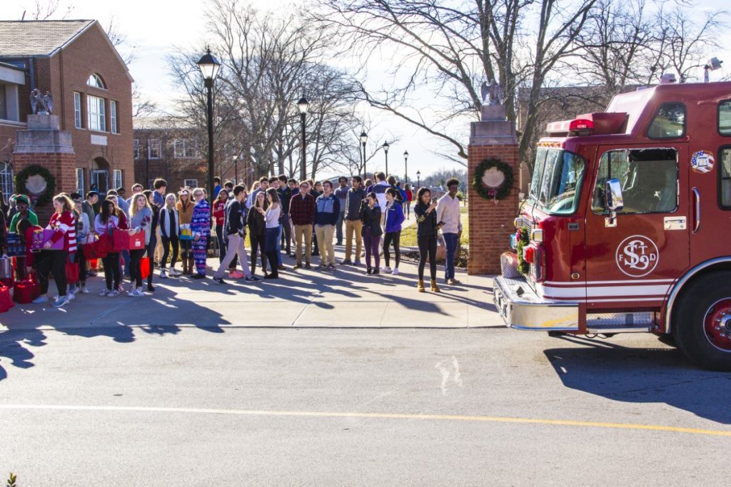 Students line up outside the fire truck for the Derek D. Martin food drive