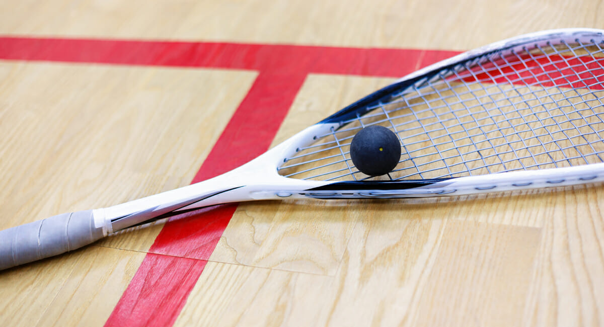 squash racket and ball on the court
