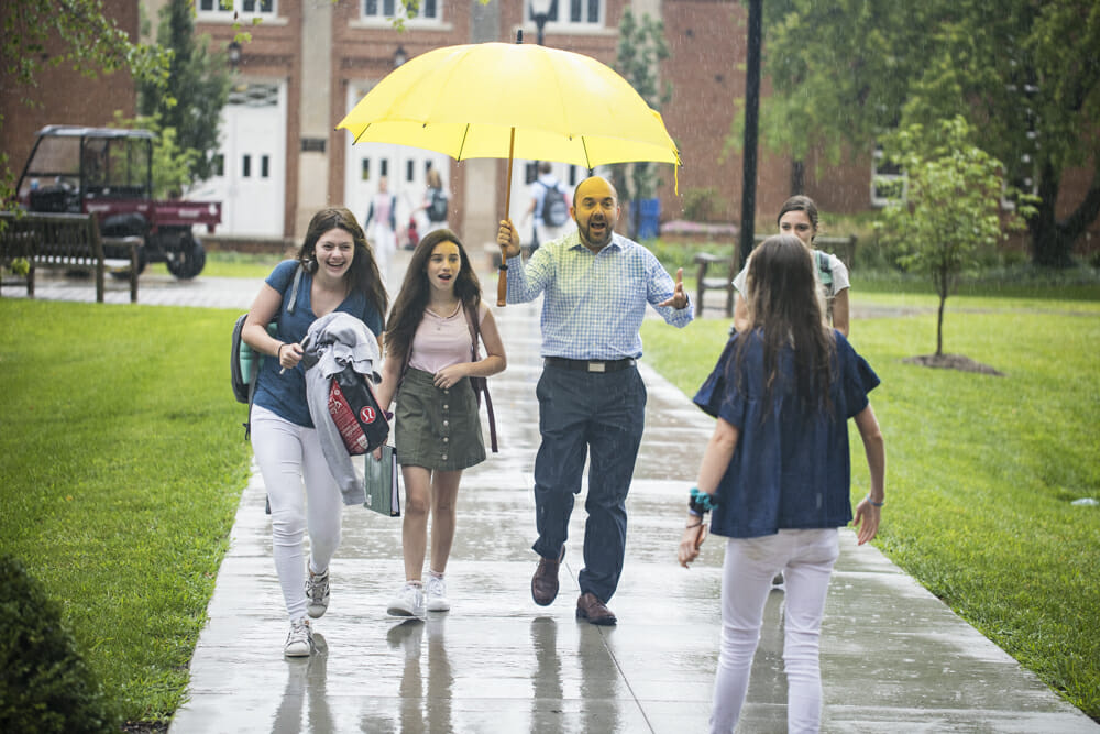 Upper Schoolers walking to class in the rain